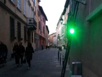 Reggio. La segnalazione. Semaforo in via Guidelli appoggiato al muro: raddrizzatelo
